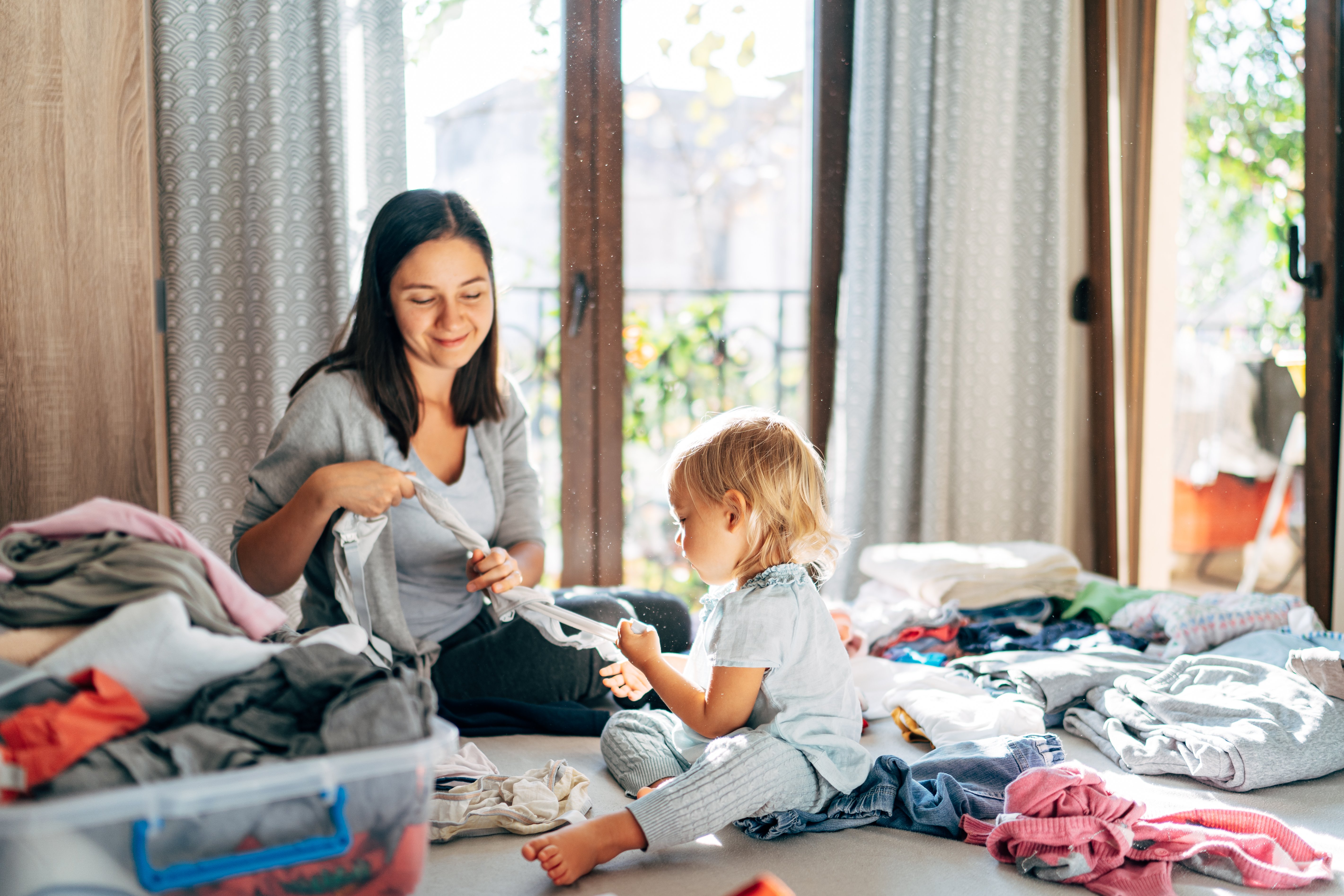 mom-and-daughter-are-folding-clothes-home-2022-09-01-17-50-16-utc