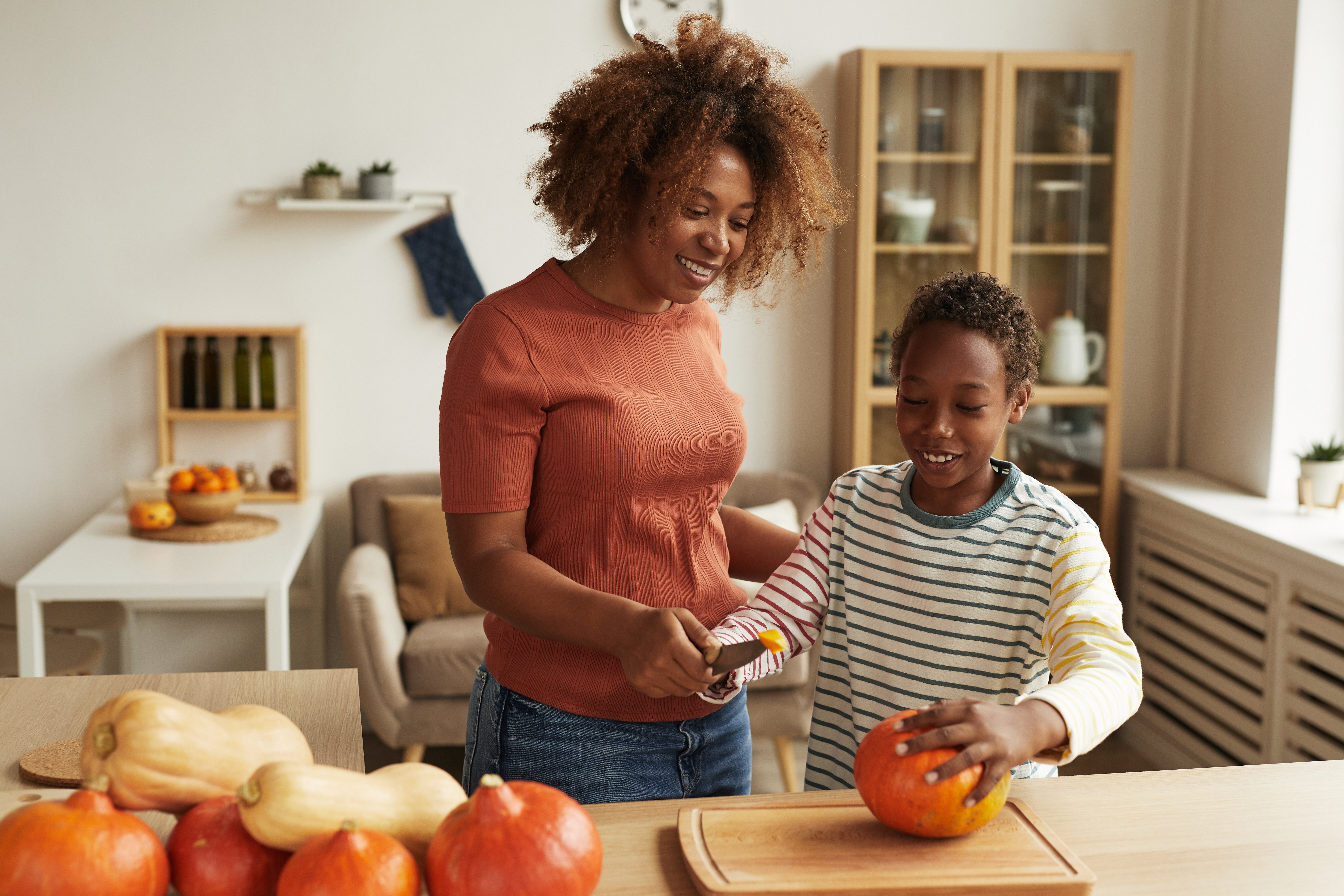 mom-and-kid-starting-pumpkin-carving-2021-09-24-04-11-55-utc